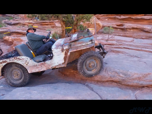 Grampa's Jeep climbing up the Z-Turn obstacle on the Moab Rim trail in Moab, Utah during Easter Jeep Safari 2017.